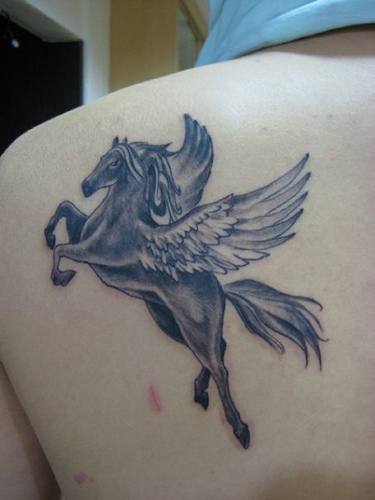 Black Unicorn With Flying Wings Tattoo On Man Left Back Shoulder