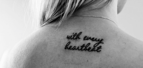 Black With Every Heartbeat Word Tattoo On Girl Upper Back
