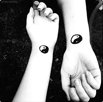 Black Yin Yang Tattoo On Couple Wrists