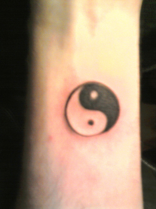 Black Yin Yang Tattoo On Forearm
