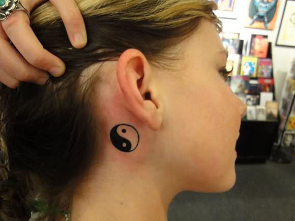 Black Yin Yang Tattoo On Girl Behind The Ear