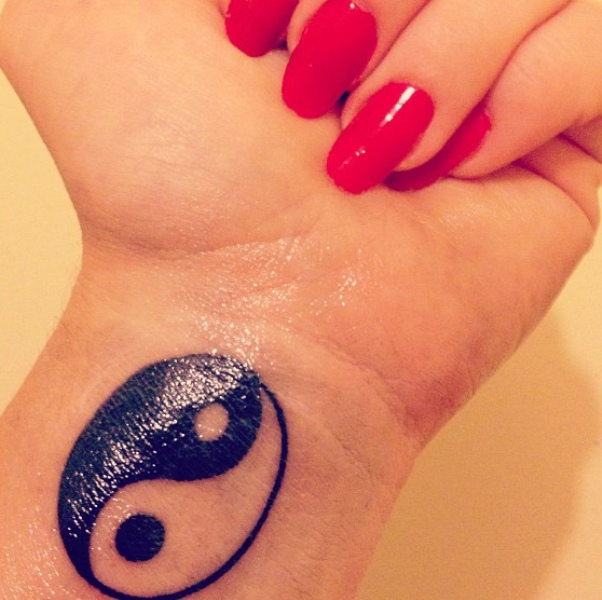 Black Yin Yang Tattoo On Girl Wrist
