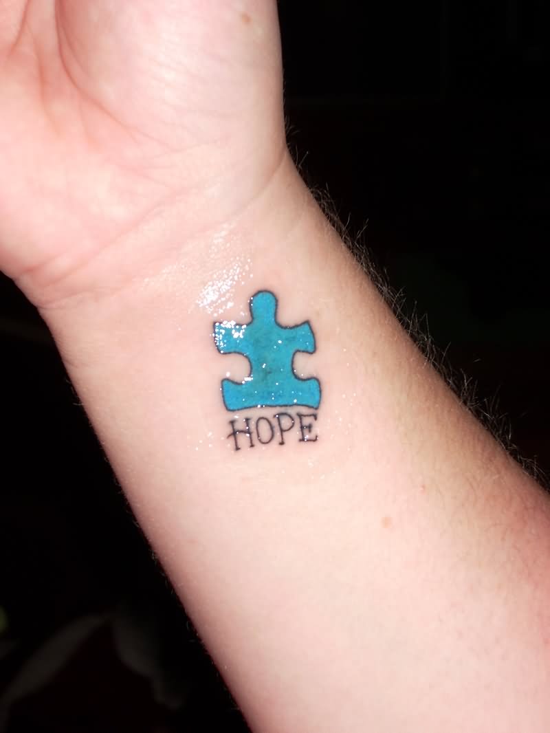 Blue Puzzle Tattoo On Wrist