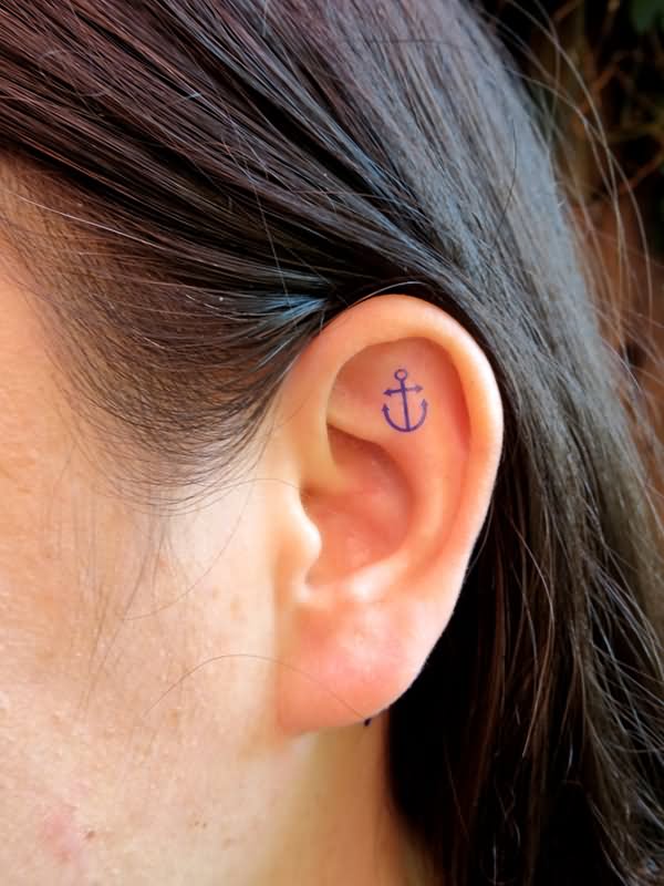 Blue Tiny Anchor Tattoo On Girl Inside The Ear