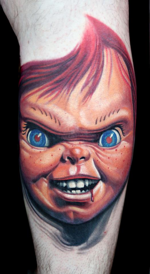 Colorful Chucky Face Tattoo On Forearm