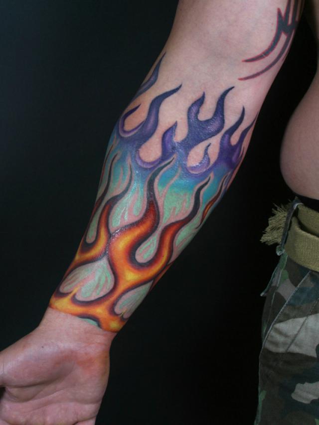 Colorful Fire Flame Tattoo On Forearm