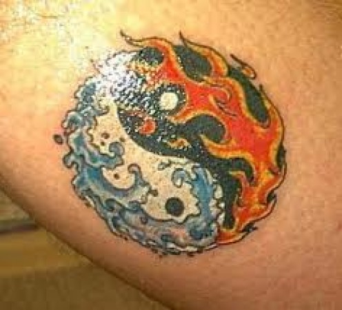Colorful Fire On Yin Yang Symbol Tattoo Design