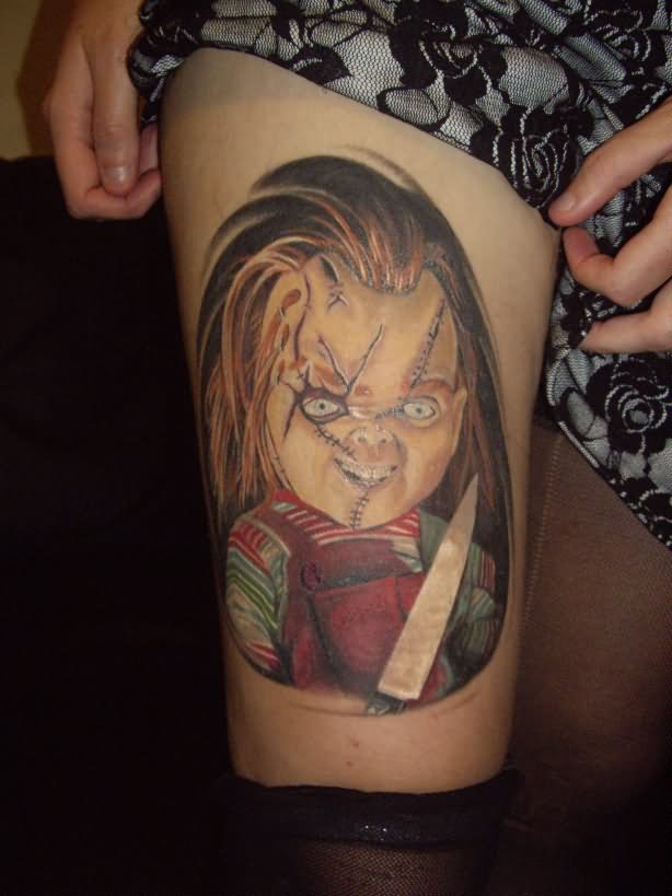 Colorful Knife On Chucky Hand Tattoo On Girl Thigh