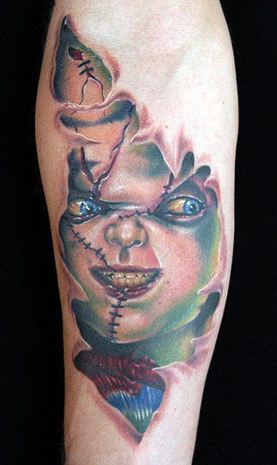 Colorful Ripped Skin Chucky Face Tattoo On Forearm