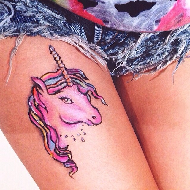 Colorful Unicorn Head Tattoo On Girl Left Thigh