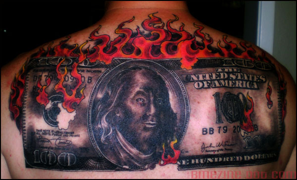 Dollar Money In Fire Flame Tattoo On Man Upper Back