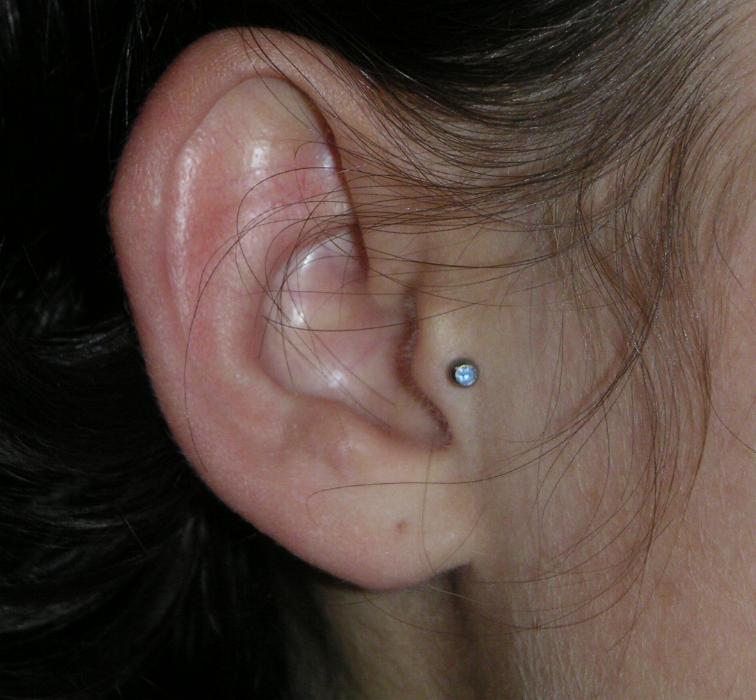 Girl Right Ear Tragus Piercing Image