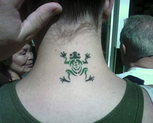 Green Tribal Frog Tattoo On Girl Back Neck