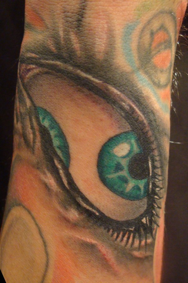 Green eye tattoo by Fabian Cobos