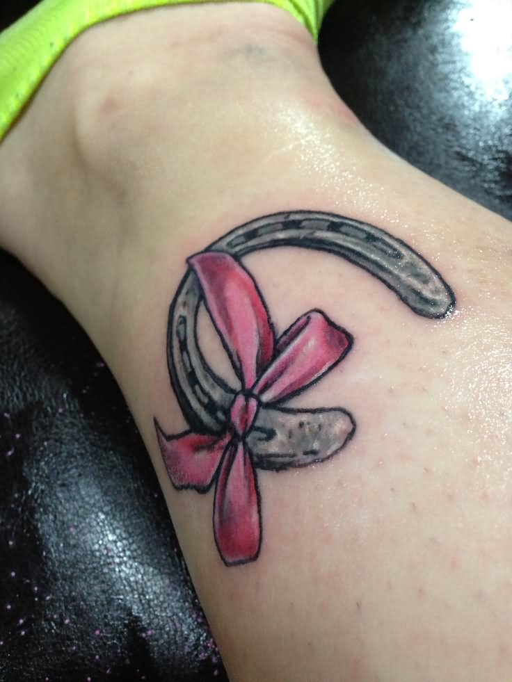 Read Complete Grey Horseshoe With Ribbon Bow Tattoo On Leg