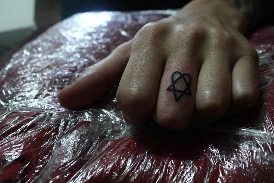 Heartagram Tattoo On Middle Finger