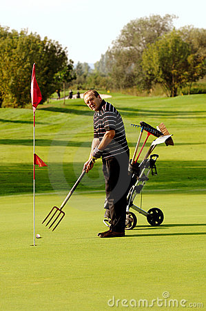 Man Playing Golf With Funny Fork Stick