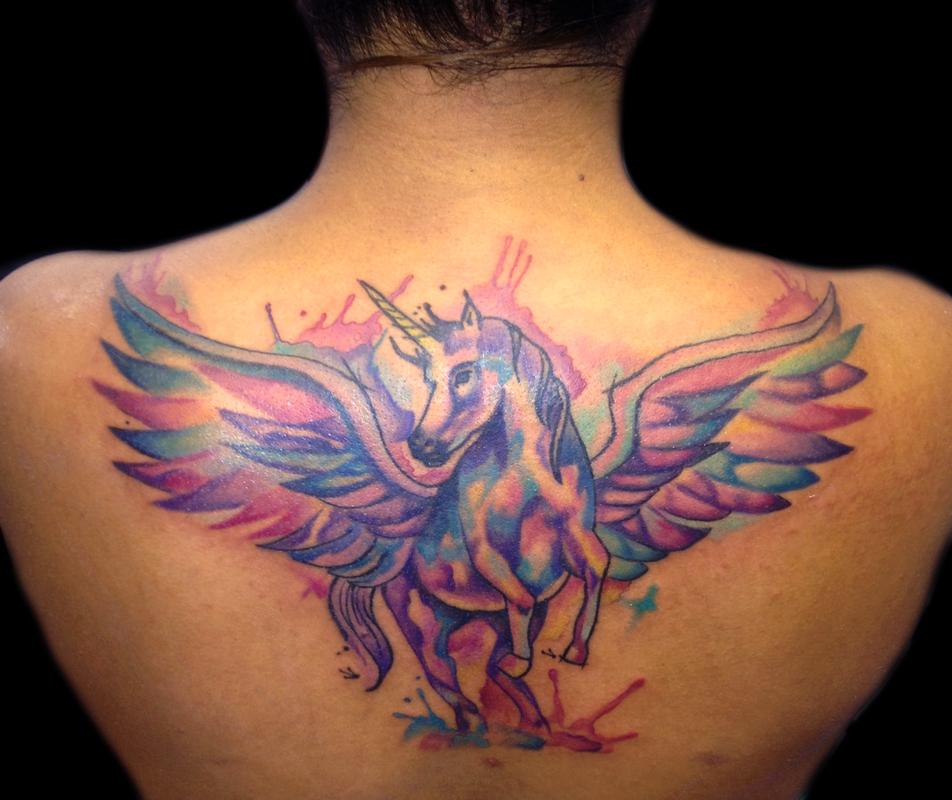 Rainbow Color Unicorn With Flying Wings Tattoo On Upper Back