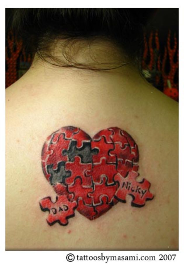 Red And Grey Heart Puzzle Tattoo On Girl Upper Back