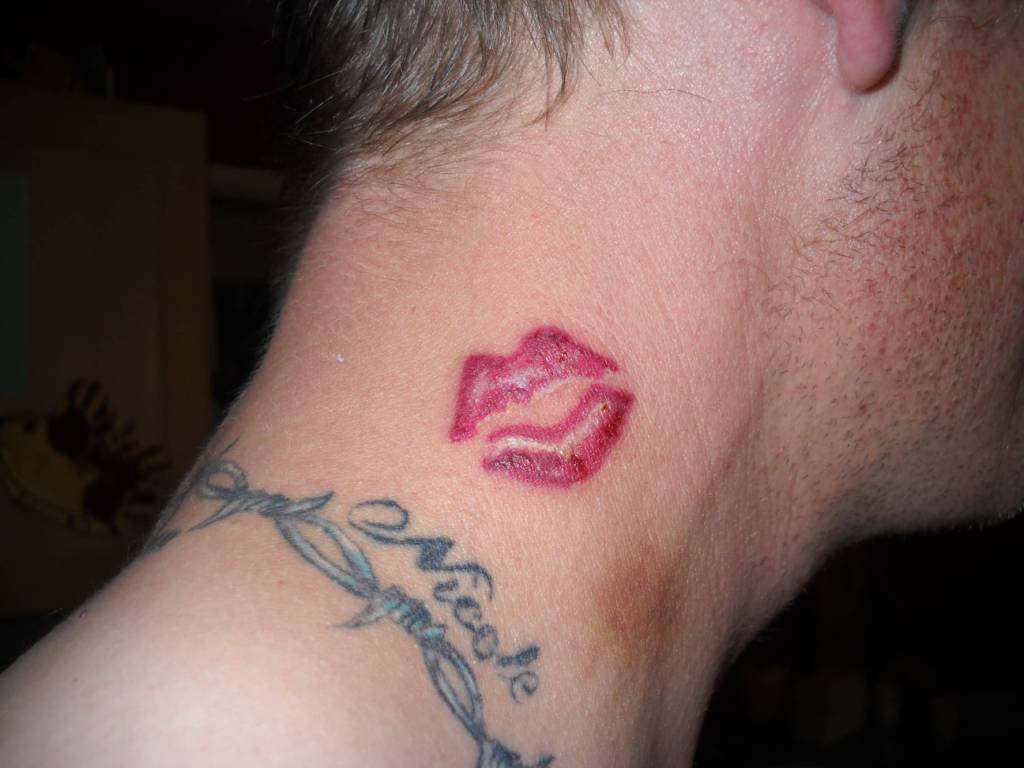 Red Lip Print Tattoo On Man Side Neck