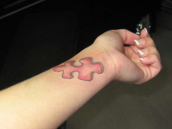 Red Puzzle Tattoo On Wrist