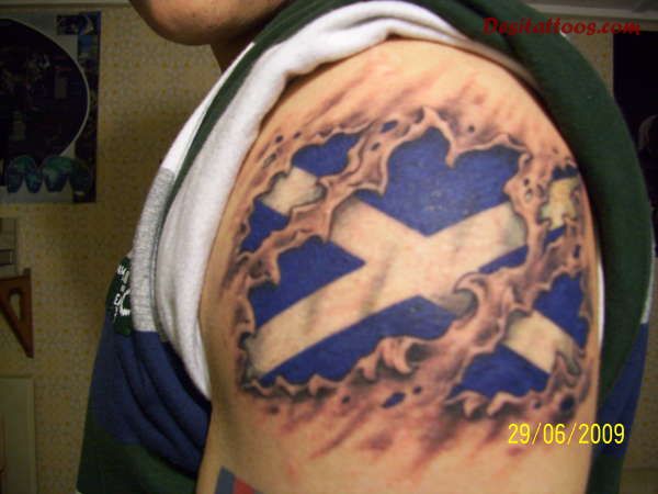 Ripped Skin Scotland Flag Tattoo On Man Shoulder