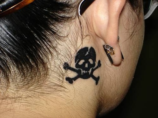Silhouette Danger Skull Tattoo On Girl Behind The Ear