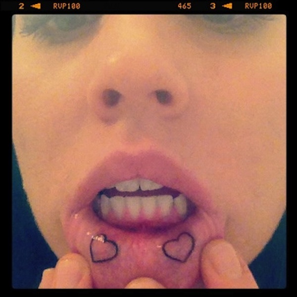 Two Black Heart Outline Tattoo On Girl Inner Lip