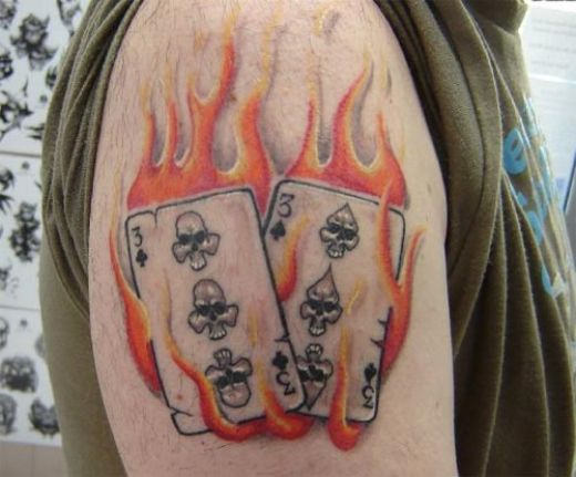 Two Playing Cards In Fire Tattoo On Shoulder