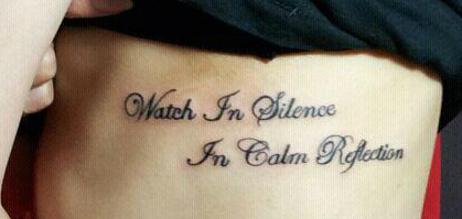 Watch In Silence In Calm Reflection Wording Tattoo On Rib Cage