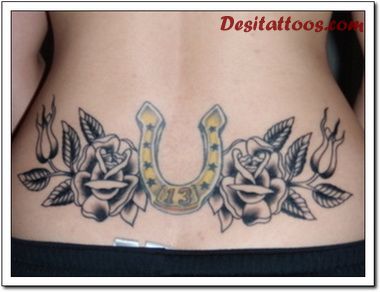 Yellow Horseshoe With Black Two Roses Tattoo On Lower Back