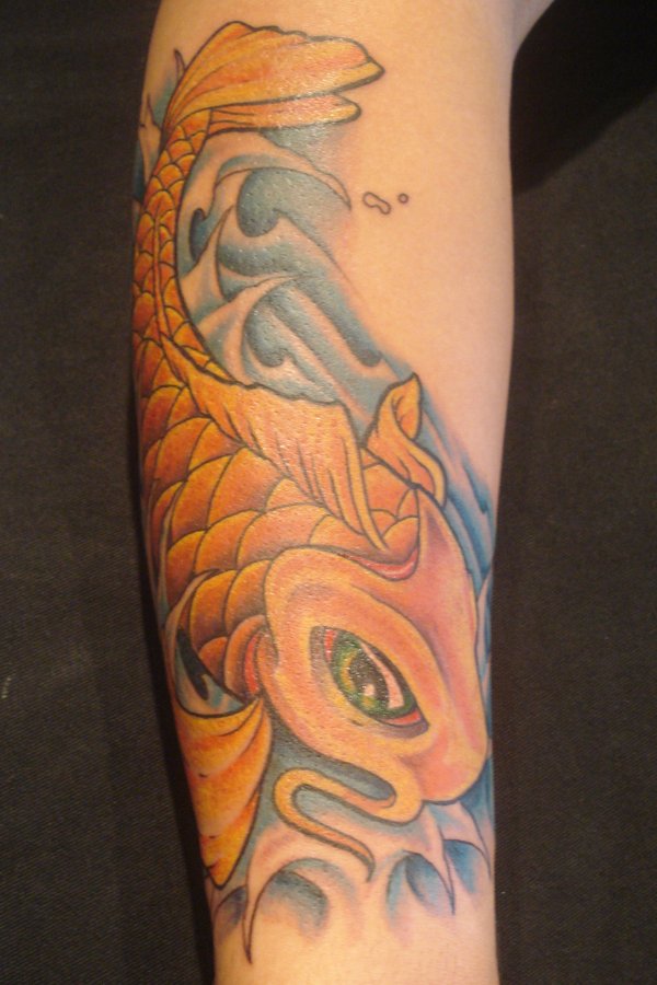 Yellow koi fish tattoo on arm