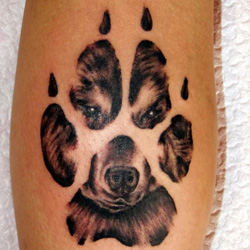 Awesome Dog Face In Paw Tattoo Design