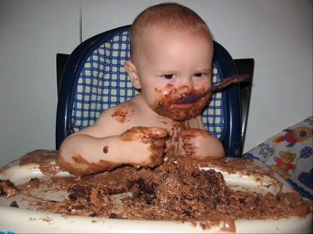 Baby Eating Cake And Making Funny Face