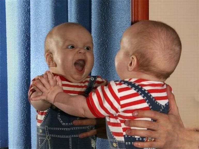 Baby See Himself In The Mirror Making Funny Face