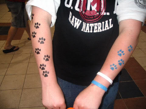 Black And Blue Paw Prints Tattoo On Both Forearm