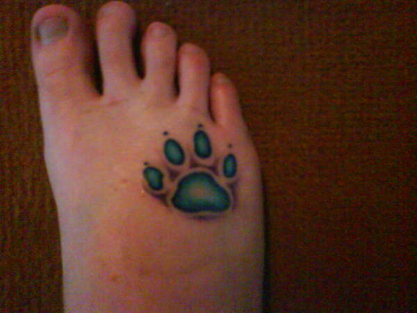 Black And Green Paw Tattoo On Foot
