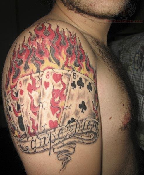 Black And Red Poker Cards With Banner In Fire Flame Tattoo On Man Shoulder
