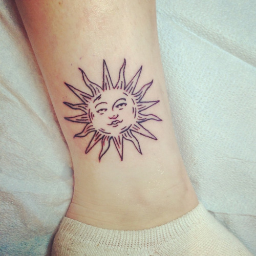 Black Cute Sun Face Tattoo On Leg
