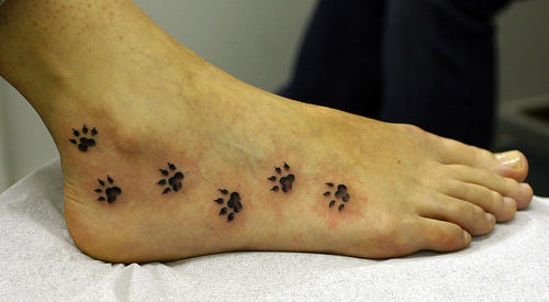 Black Paw Prints Tattoo On Foot