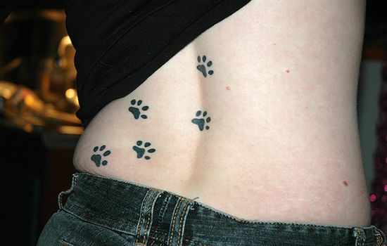 Black Paw Prints Tattoo On Lower Back