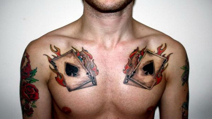 Black Poker Card In Fire Flame Tattoo On Chest