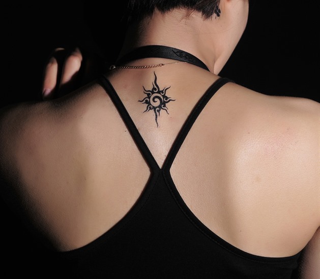 Black Tiny Tribal Sun Tattoo On Upper Back