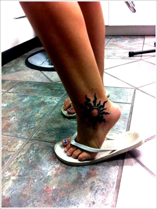 Black Tribal Sun Tattoo On Girl Ankle