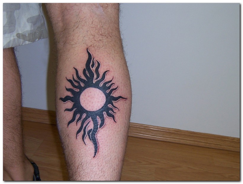 Black Tribal Sun Tattoo On Man Leg Calf