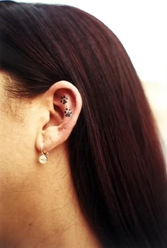 Black Two Paw Tattoo On Girl Ear