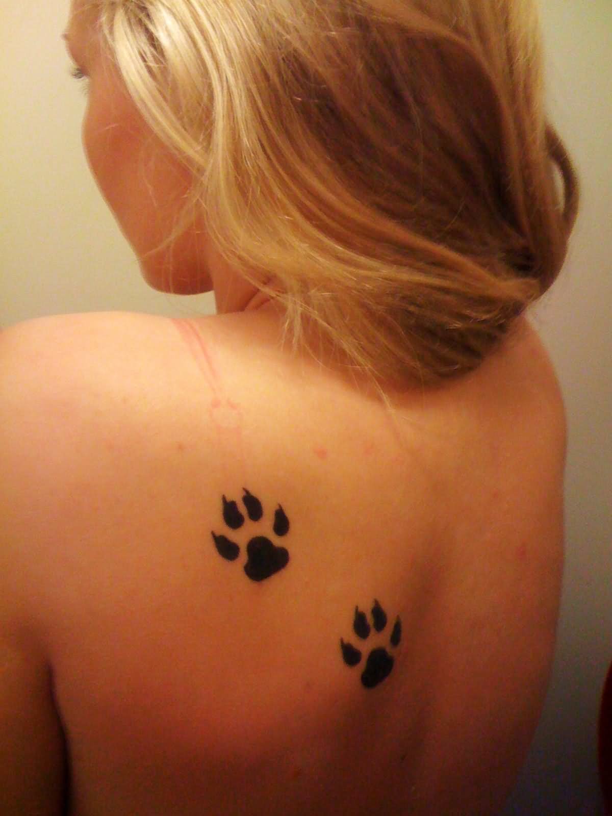 Black Wolf Paw Print Tattoo On Girl Upper Back