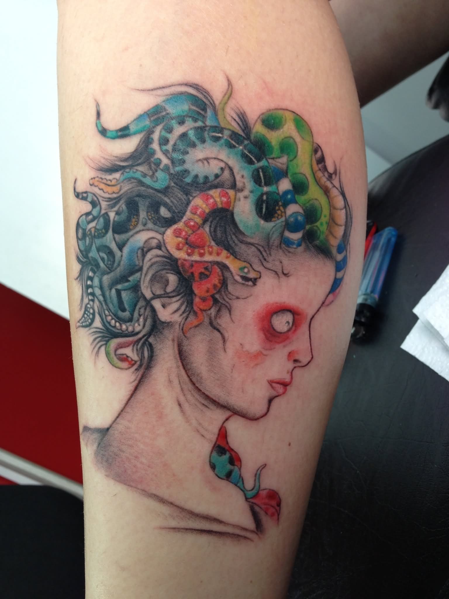 Colorful Medusa Face Tattoo On Leg Calf