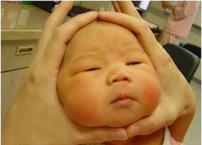 Cute Baby Face In Hand Funny Picture