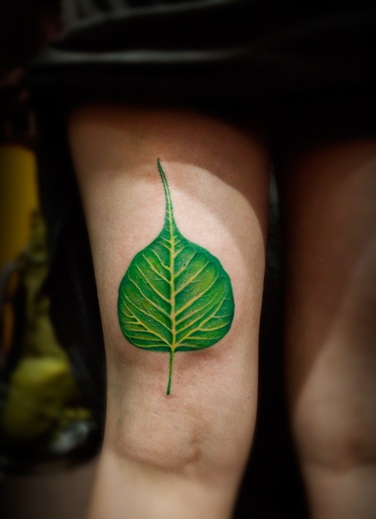 Green Banyan Leaf Tattoo On Girl Thigh